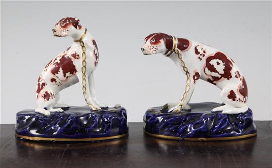 A pair of English porcelain figures of seated hounds, c.1830, 11.5cm and 12.5cm, flaking to enamels